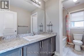 Clarington (Bowmanville) apartment for rent - A bathroom with a marble countertop and a toilet.