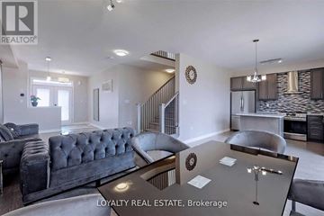 Clarington (Bowmanville) apartment for rent - A modern living room with a grey sofa and a glass coffee table.