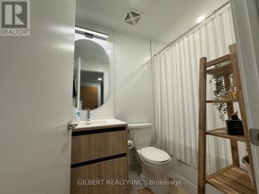 Vaughan (Beverley Glen) condo for rent - A bathroom with a toilet, sink, mirror, and a wooden ladder.