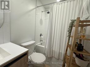 Vaughan (Beverley Glen) condo for rent - A white bathroom with a toilet, sink, and shower.