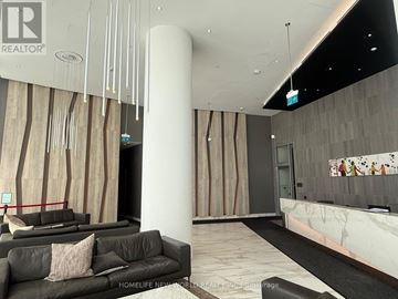 Mississauga (City Centre) condo for rent - A modern living room with a black couch and a marble floor.