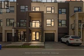 Burlington (Lasalle) townhouse for rent - A white car is parked in front of a building with a sign that says RE/MAX Escarpment Realty Inc., Brokerage.
