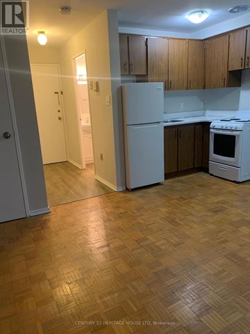 St. Thomas condo for rent - A kitchen with wooden floors and white appliances.