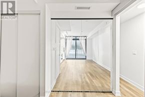 Hamilton (Beasley) condo for rent - A long hallway with a door on the left and a window on the right.