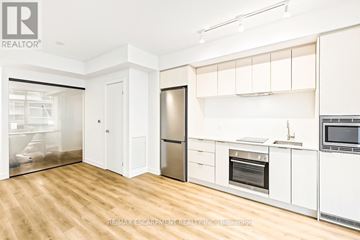 Hamilton (Beasley) condo for rent - A modern kitchen with white cabinets and stainless steel appliances.