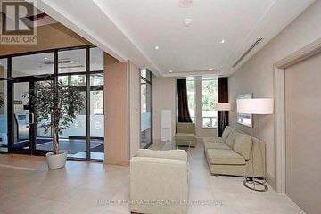 Mississauga (City Centre) condo for rent - A spacious living room with a white sofa and a potted plant.
