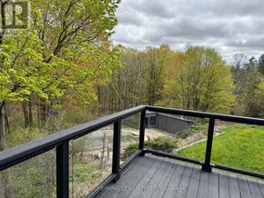 Caledon (Palgrave) apartment for rent - A deck with a railing overlooking a wooded area.