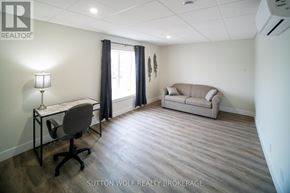 Strathroy-Caradoc (Nw) multi-family for rent - A room with a desk, chair, and couch.