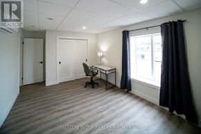 Strathroy-Caradoc (Nw) multi-family for rent - A room with a desk and a chair in it.