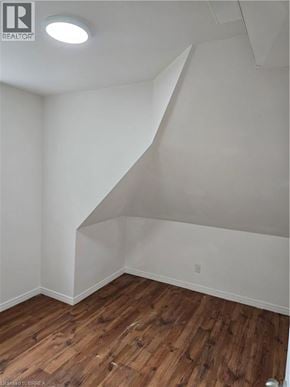 Brantford apartment for rent - A room with wooden flooring and white walls.