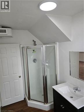 Brantford apartment for rent - A bathroom with a white sink and a glass shower stall.