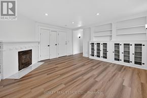 Niagara-On-The-Lake (Town) apartment for rent - A spacious room with wooden flooring and white walls.