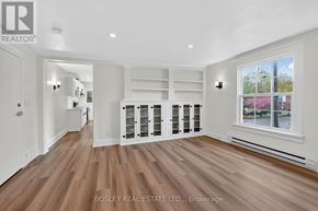 Niagara-On-The-Lake (Town) apartment for rent - A spacious room with wooden flooring and a large window.