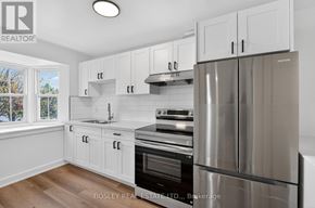Niagara-On-The-Lake (Town) apartment for rent - A modern kitchen with white cabinets and stainless steel appliances.