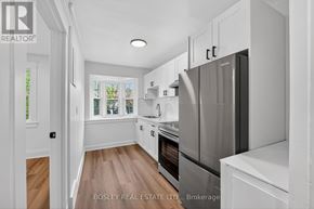 Niagara-On-The-Lake (Town) apartment for rent - A modern kitchen with a refrigerator, oven, and sink.