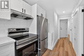 Niagara-On-The-Lake (Town) apartment for rent - A kitchen with white cabinets and a stainless steel refrigerator.