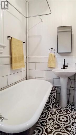 Hamilton apartment for rent - A white bathroom with a black and white floor.
