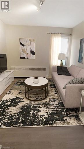 Hamilton apartment for rent - A living room with a black and white rug, a grey couch, and a coffee table.