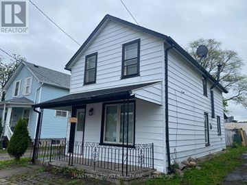 Niagara Falls (Downtown) apartment for rent - A white house with a black fence in front of it.