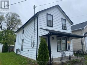 Niagara Falls (Downtown) apartment for rent - A white house with a black roof and a black fence.