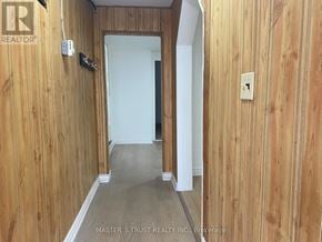 Niagara Falls (Downtown) apartment for rent - A hallway with wood paneling and a white door.