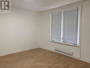 Niagara Falls (Downtown) apartment for rent - A room with a window and a wooden floor.