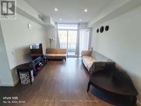 Kitchener condo for rent - A living room with a couch, a chair, and a coffee table.