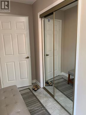 Brampton (Fletcher's Creek South) apartment for rent - A hallway with a white door and a mirror on the wall.