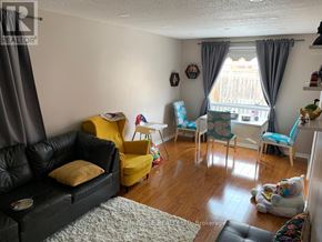 Brampton (Fletcher's Creek South) apartment for rent - A living room with a black leather couch and yellow chair.