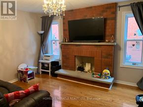 Brampton (Fletcher's Creek South) apartment for rent - A living room with a brick fireplace and a flat screen TV mounted above it.