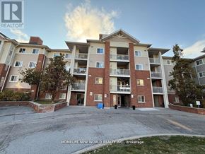 Toronto (Agincourt North) condo for rent - A large apartment complex with a blue trash bin in front.