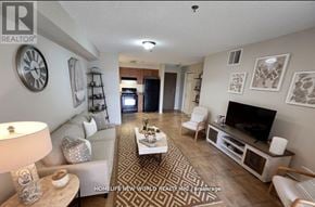 Toronto (Agincourt North) condo for rent - A living room with a couch, a coffee table, and a television.