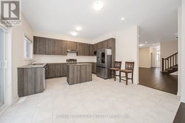 Wellington North (Arthur) apartment for rent - A spacious kitchen with wooden cabinets and a refrigerator.