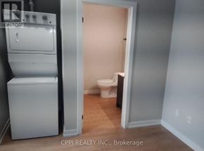 Peterborough (Town Ward 3) condo for rent - A small room with a toilet and a washer and dryer.