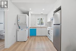 Toronto (Yorkdale-Glen Park) apartment for rent - A kitchen with white appliances and a blue drawer.