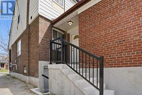 Toronto (Yorkdale-Glen Park) apartment for rent - A brick building with a black railing and steps leading to a door.