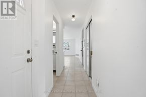 Toronto (Yorkdale-Glen Park) apartment for rent - A white hallway with a door on the left and a window on the right.