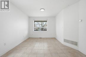 Toronto (Yorkdale-Glen Park) apartment for rent - A white room with a window and tiled floor.