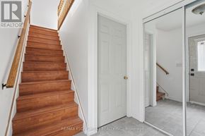 Toronto (Yorkdale-Glen Park) apartment for rent - A wooden staircase with a white door in the background.