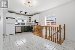 Toronto (Yorkdale-Glen Park) apartment for rent - A white kitchen with a wooden railing.
