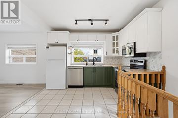 Toronto (Yorkdale-Glen Park) apartment for rent - A kitchen with white cabinets and a green island.