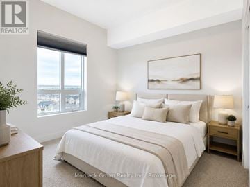 Oakville (Wm Westmount) condo for rent - A bedroom with a large bed and a painting on the wall.