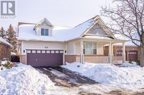 Milton (Be Beaty) apartment for rent - A house with a snow-covered roof and a driveway in front.