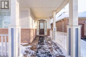 Milton (Be Beaty) apartment for rent - A snowy porch with a brown door and a sign that says REALTOR.