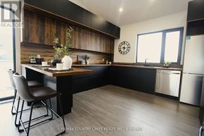 Kawartha Lakes (Carden) apartment for rent - A kitchen with a wooden counter and a white chair.
