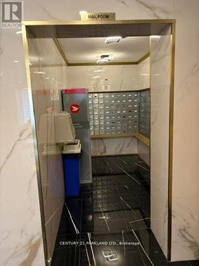 Toronto (Flemingdon Park) condo for rent - A bathroom with a marble floor and walls, a toilet, a sink, and a mailbox.