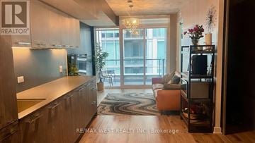 Toronto (South Riverdale) condo for rent - A modern kitchen with wooden cabinets and a large window.