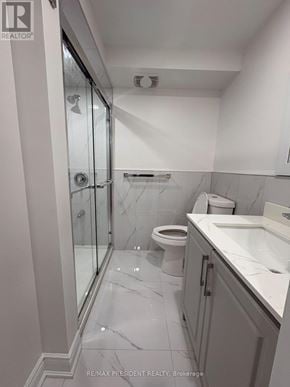 Pickering (Brock Ridge) apartment for rent - A white bathroom with a toilet, sink, and shower.