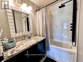 Richmond Hill (Westbrook) apartment for rent - A bathroom with a marble countertop and a large mirror.