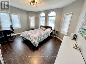 Richmond Hill (Westbrook) apartment for rent - A bedroom with a large bed and a desk with a chair.